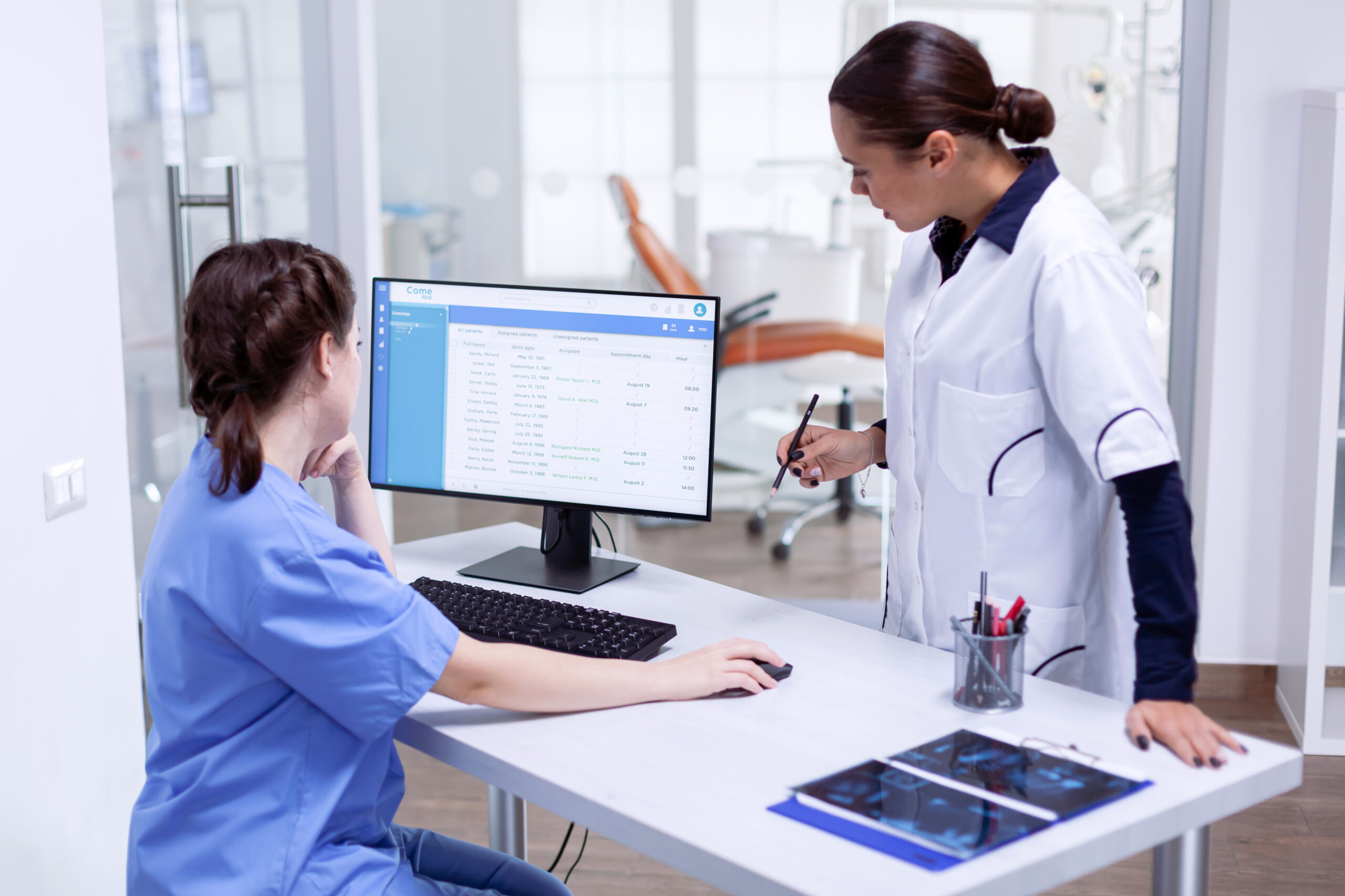 stomatolog and nurse in tooth clinic checking patient appointment.